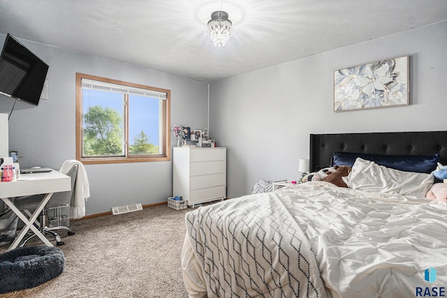 46687 276th St, Lennox, SD 57039 - carpeted bedroom featuring baseboards and a chandelier
