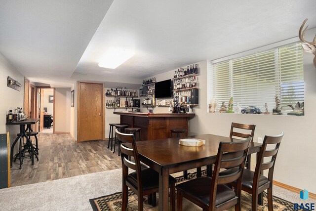 46687 276th St, Lennox, SD 57039 - dining area featuring a dry bar, wood finished floors, and baseboards