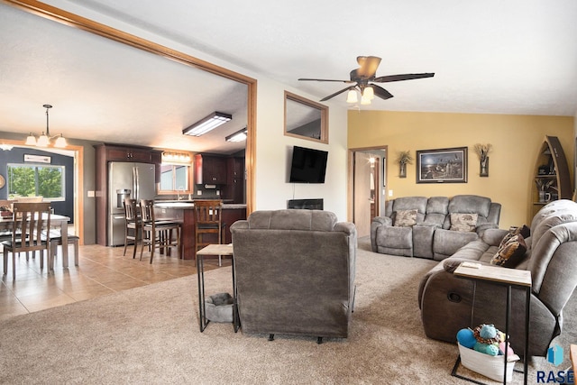 46687 276th St, Lennox, SD 57039 - living area featuring a ceiling fan, light colored carpet, vaulted ceiling, and light tile patterned floors