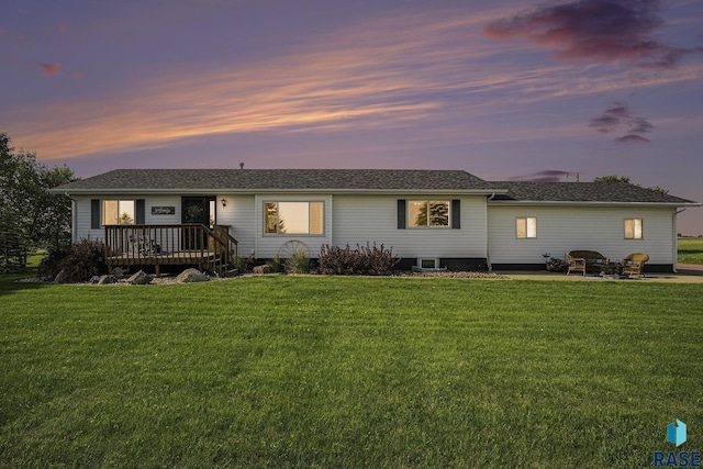 46687 276th St, Lennox, SD 57039 - back of house at dusk featuring a yard, a patio, and a deck