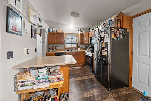 510 Kent St, Harrisburg, SD 57032 - kitchen featuring appliances with stainless steel finishes, a sink, dark wood finished floors, and brown cabinetry