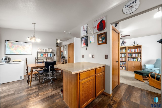 510 Kent St, Harrisburg, SD 57032 - kitchen with fridge, dark wood-style flooring, brown cabinetry, open floor plan, and vaulted ceiling
