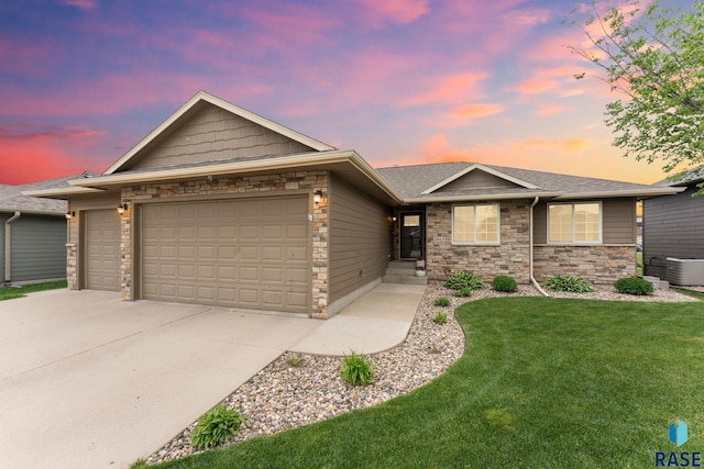 1913 S Haraldson Ave, Sioux Falls, SD 57106 - ranch-style home featuring a garage, stone siding, and driveway