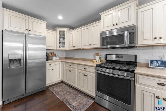 1913 S Haraldson Ave, Sioux Falls, SD 57106 - kitchen with appliances with stainless steel finishes, light countertops, dark wood-style floors, backsplash, and recessed lighting