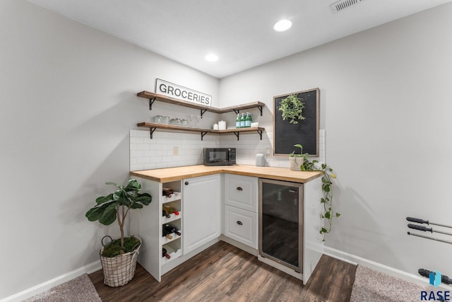 1913 S Haraldson Ave, Sioux Falls, SD 57106 - indoor bar with wine cooler, baseboards, black microwave, dark wood-style flooring, and recessed lighting