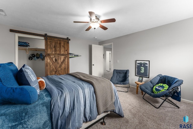 1913 S Haraldson Ave, Sioux Falls, SD 57106 - carpeted bedroom featuring a barn door, a ceiling fan, baseboards, and a closet