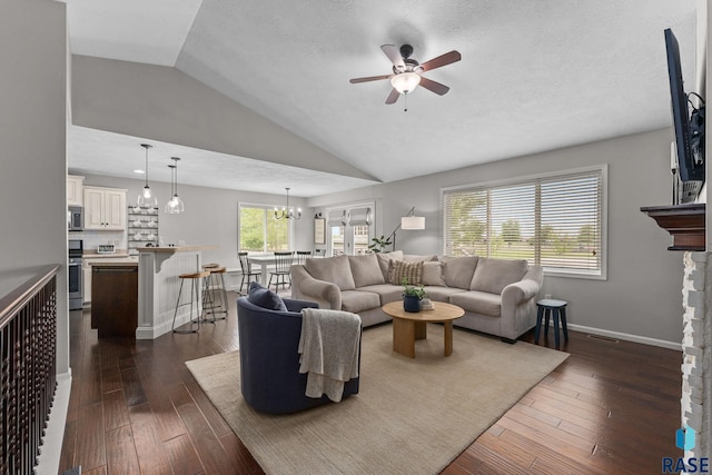 1913 S Haraldson Ave, Sioux Falls, SD 57106 - living room featuring a ceiling fan, lofted ceiling, dark wood finished floors, baseboards, and a chandelier