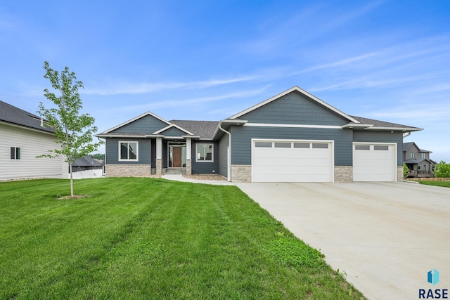 5604 E Daybreak Cir, Sioux Falls, SD 57110 - craftsman inspired home featuring a garage, driveway, stone siding, and a front yard