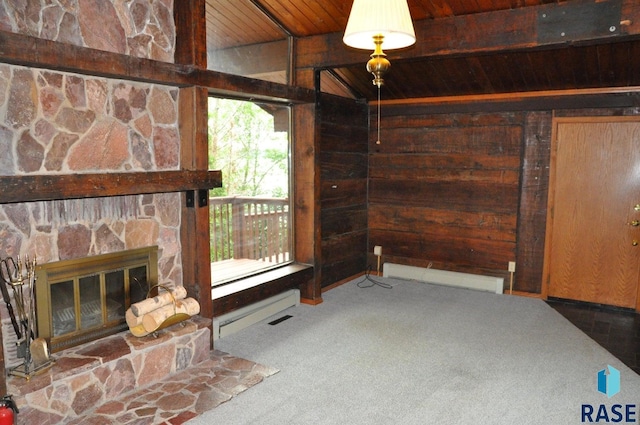 8740 Westview Rd, Brookings, SD 57006 - unfurnished living room featuring wood ceiling, carpet, baseboard heating, wood walls, and a stone fireplace