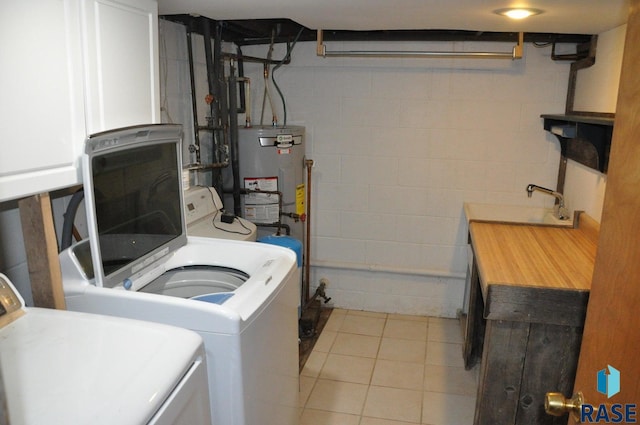 8740 Westview Rd, Brookings, SD 57006 - laundry area with concrete block wall, washer and clothes dryer, light tile patterned floors, and water heater