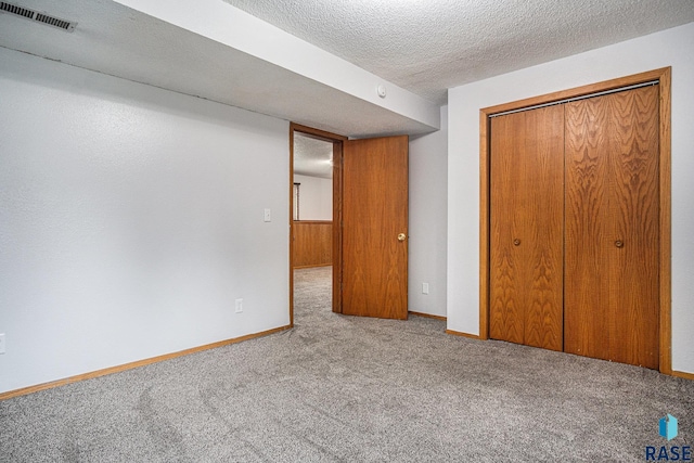 905 S Suburban Dr, Sioux Falls, SD 57110 - unfurnished bedroom with carpet floors, a closet, a textured ceiling, and baseboards