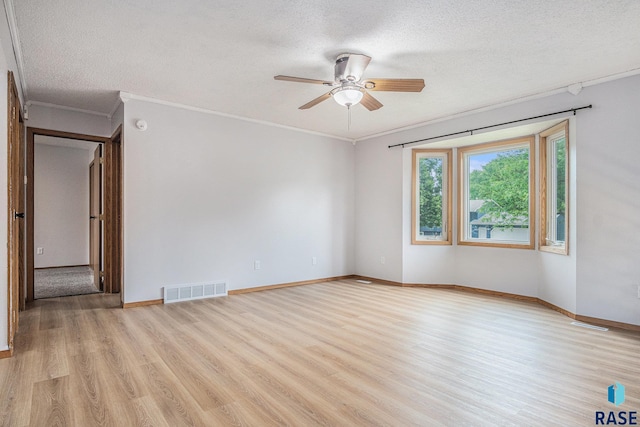 905 S Suburban Dr, Sioux Falls, SD 57110 - unfurnished room with wood finished floors, a textured ceiling, a ceiling fan, crown molding, and baseboards