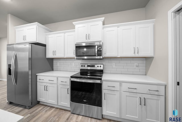 9001 W Rathburn St, Sioux Falls, SD 57103 - kitchen with stainless steel appliances, light wood-type flooring, light countertops, white cabinets, and backsplash
