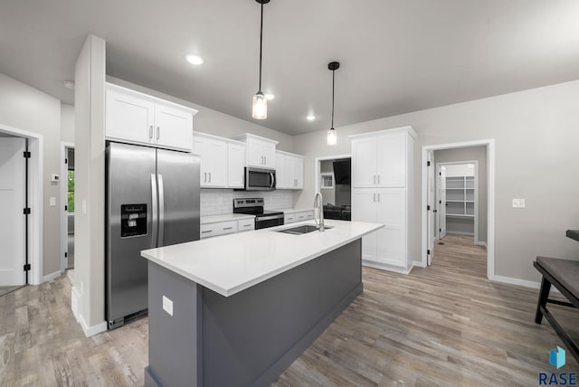9001 W Rathburn St, Sioux Falls, SD 57103 - kitchen with appliances with stainless steel finishes, a sink, light wood-type flooring, white cabinetry, and recessed lighting