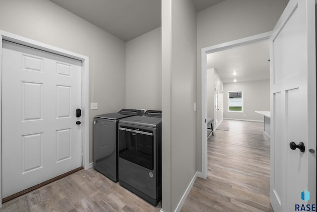 9001 W Rathburn St, Sioux Falls, SD 57103 - laundry room with independent washer and dryer, light wood-type flooring, and baseboards