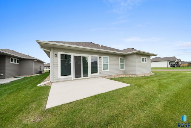 9001 W Rathburn St, Sioux Falls, SD 57103 - rear view of house with a patio and a lawn