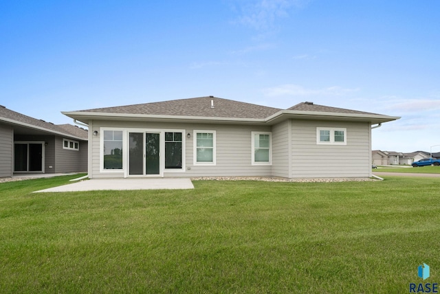 9001 W Rathburn St, Sioux Falls, SD 57103 - back of property featuring a patio, a lawn, and roof with shingles