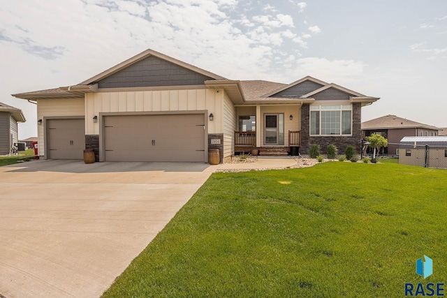 2604 S Ronell Cir, Sioux Falls, SD 57106 - view of front facade with a garage, concrete driveway, and stone siding