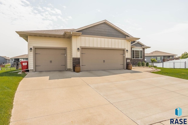 2604 S Ronell Cir, Sioux Falls, SD 57106 - view of front facade with an attached garage, concrete driveway, board and batten siding, and stone siding