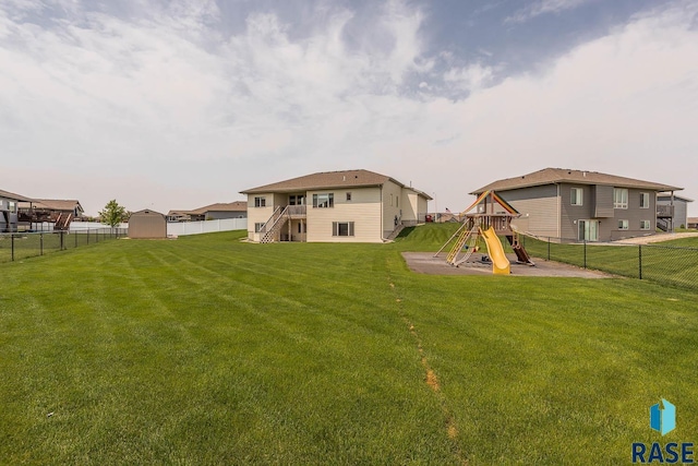 2604 S Ronell Cir, Sioux Falls, SD 57106 - rear view of house with a playground, stairway, and a residential view