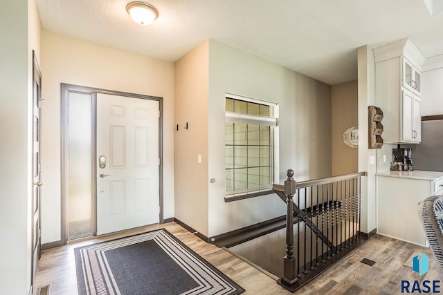 2604 S Ronell Cir, Sioux Falls, SD 57106 - foyer entrance with light wood-style floors and baseboards