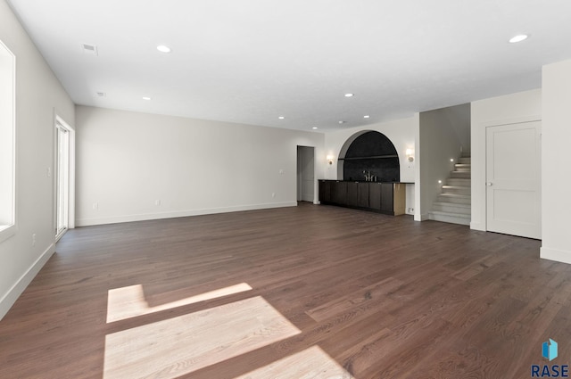 8309 E Sheridan Cir, Sioux Falls, SD 57110 - unfurnished living room with a fireplace, recessed lighting, stairs, dark wood-style flooring, and baseboards