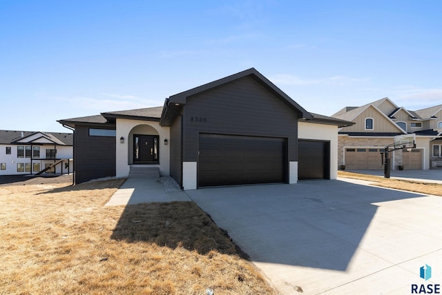 8309 E Sheridan Cir, Sioux Falls, SD 57110 - view of front facade featuring an attached garage, driveway, and brick siding