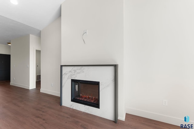 8309 E Sheridan Cir, Sioux Falls, SD 57110 - unfurnished living room featuring wood finished floors, baseboards, and a high end fireplace