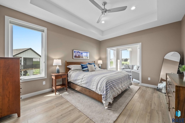 1703 N Otto Ave, Sioux Falls, SD 57110 - bedroom featuring a raised ceiling, multiple windows, baseboards, light wood finished floors, and recessed lighting