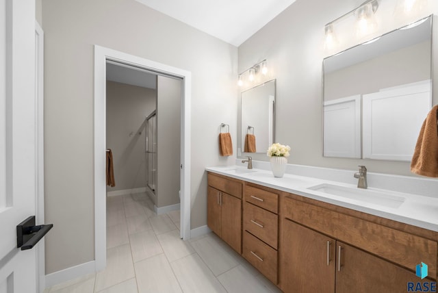 1703 N Otto Ave, Sioux Falls, SD 57110 - full bathroom with double vanity, a stall shower, baseboards, and toilet