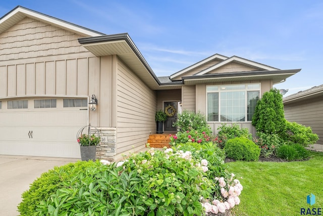8216 W 51st St, Sioux Falls, SD 57106 - ranch-style home featuring an attached garage, driveway, and board and batten siding