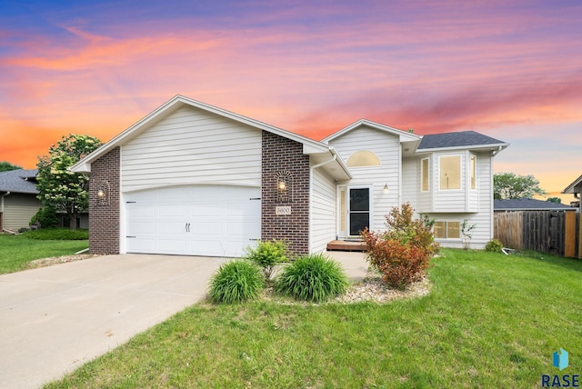 5600 W Darcie St, Sioux Falls, SD 57106 - split level home with a garage, driveway, and brick siding