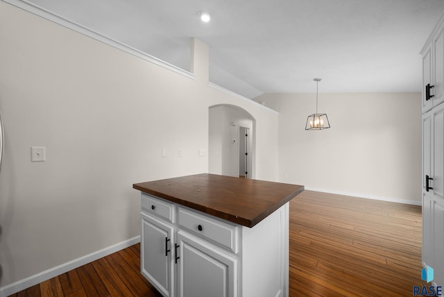 5600 W Darcie St, Sioux Falls, SD 57106 - kitchen featuring butcher block counters, arched walkways, a chandelier, dark wood-style floors, and vaulted ceiling