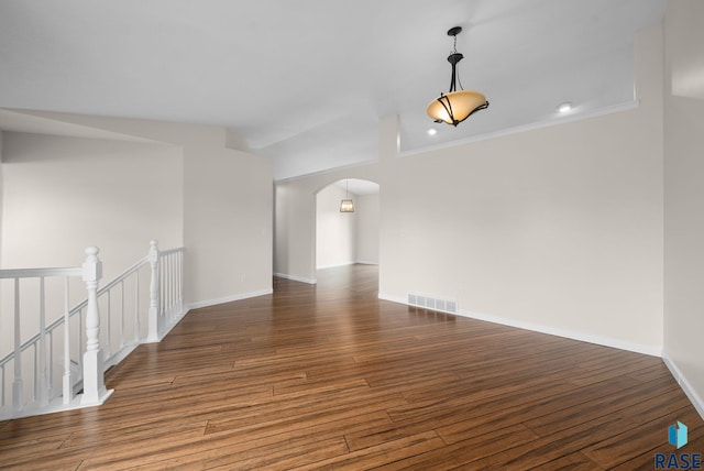5600 W Darcie St, Sioux Falls, SD 57106 - spare room with arched walkways, wood finished floors, baseboards, and crown molding