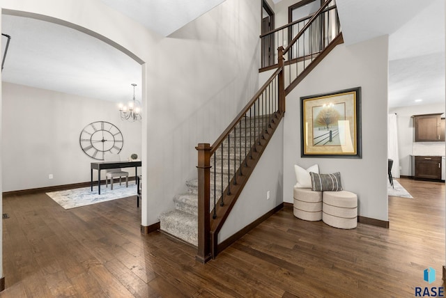 2101 S Meadowview Ave, Sioux Falls, SD 57110 - stairs featuring hardwood / wood-style flooring, arched walkways, and baseboards