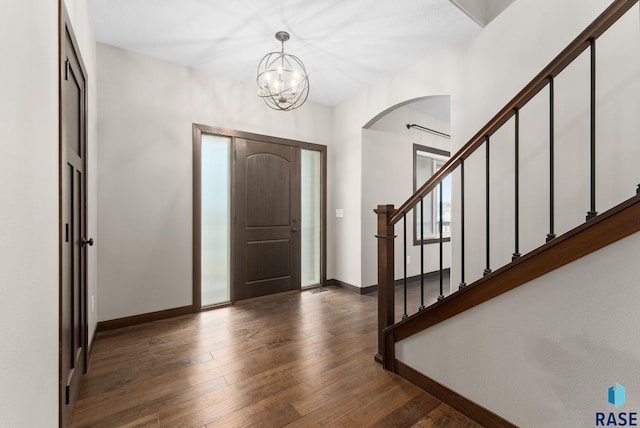 2101 S Meadowview Ave, Sioux Falls, SD 57110 - foyer with arched walkways, baseboards, hardwood / wood-style floors, stairs, and a chandelier