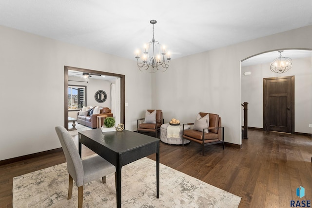 2101 S Meadowview Ave, Sioux Falls, SD 57110 - dining room with arched walkways, dark wood-style flooring, a chandelier, and baseboards