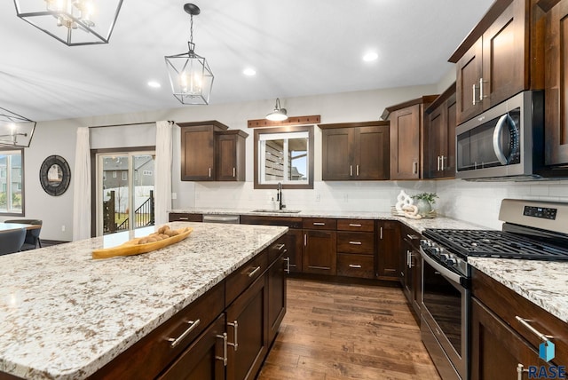 2101 S Meadowview Ave, Sioux Falls, SD 57110 - kitchen featuring stainless steel appliances, a sink, dark wood-style floors, tasteful backsplash, and recessed lighting