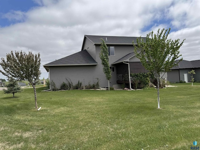 2101 S Meadowview Ave, Sioux Falls, SD 57110 - rear view of property with a yard and a shingled roof