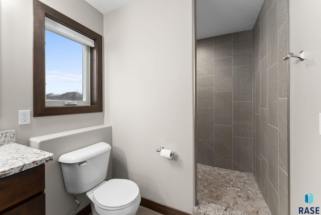 2101 S Meadowview Ave, Sioux Falls, SD 57110 - full bathroom featuring vanity, toilet, tiled shower, and baseboards