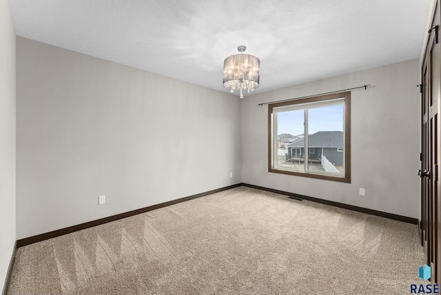 2101 S Meadowview Ave, Sioux Falls, SD 57110 - carpeted spare room featuring a chandelier and baseboards