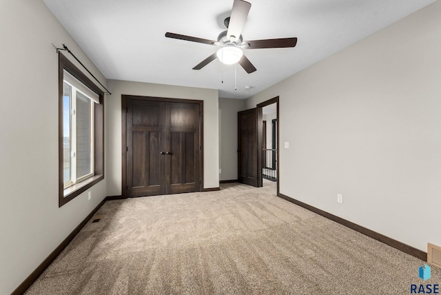 2101 S Meadowview Ave, Sioux Falls, SD 57110 - unfurnished bedroom featuring light colored carpet, baseboards, and ceiling fan