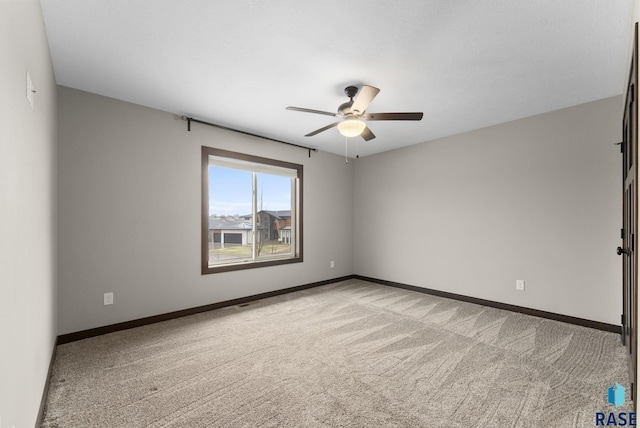 2101 S Meadowview Ave, Sioux Falls, SD 57110 - spare room with light carpet, ceiling fan, and baseboards