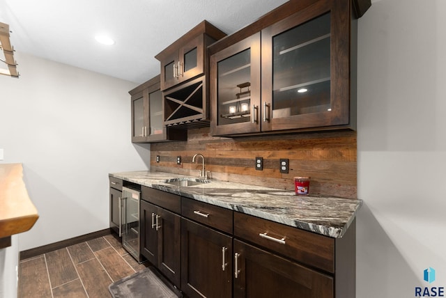 2101 S Meadowview Ave, Sioux Falls, SD 57110 - bar area with beverage cooler, a sink, dark wood-style floors, baseboards, and backsplash