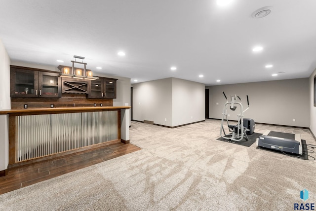 2101 S Meadowview Ave, Sioux Falls, SD 57110 - workout room with baseboards, wet bar, recessed lighting, light carpet, and light wood-style floors