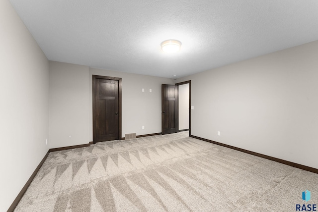 2101 S Meadowview Ave, Sioux Falls, SD 57110 - empty room featuring light colored carpet, baseboards, and a textured ceiling