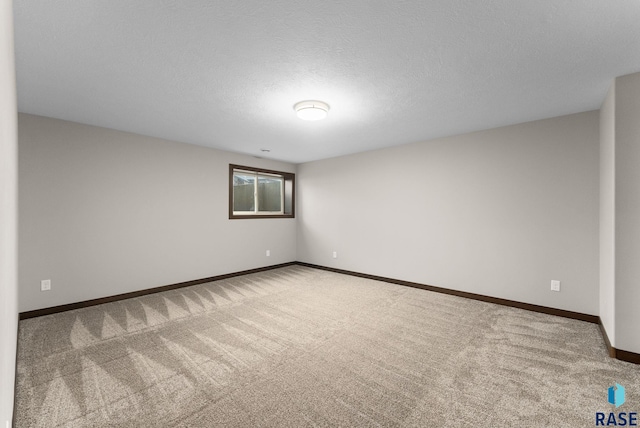 2101 S Meadowview Ave, Sioux Falls, SD 57110 - unfurnished room with carpet flooring, baseboards, and a textured ceiling