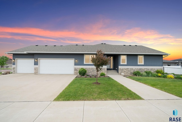 8620 W 22nd St, Sioux Falls, SD 57106 - view of front of property with a garage, stone siding, concrete driveway, and roof with shingles