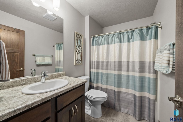 8620 W 22nd St, Sioux Falls, SD 57106 - full bathroom featuring vanity, wood finished floors, and a textured ceiling