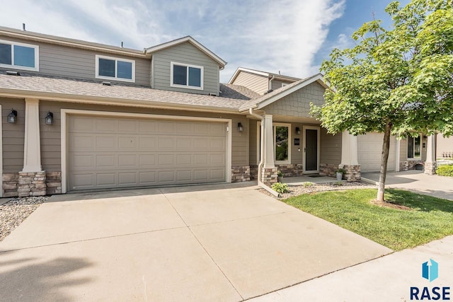 2905 E Fieldstone Pl, Sioux Falls, SD 57108 - townhome / multi-family property featuring stone siding, driveway, and roof with shingles
